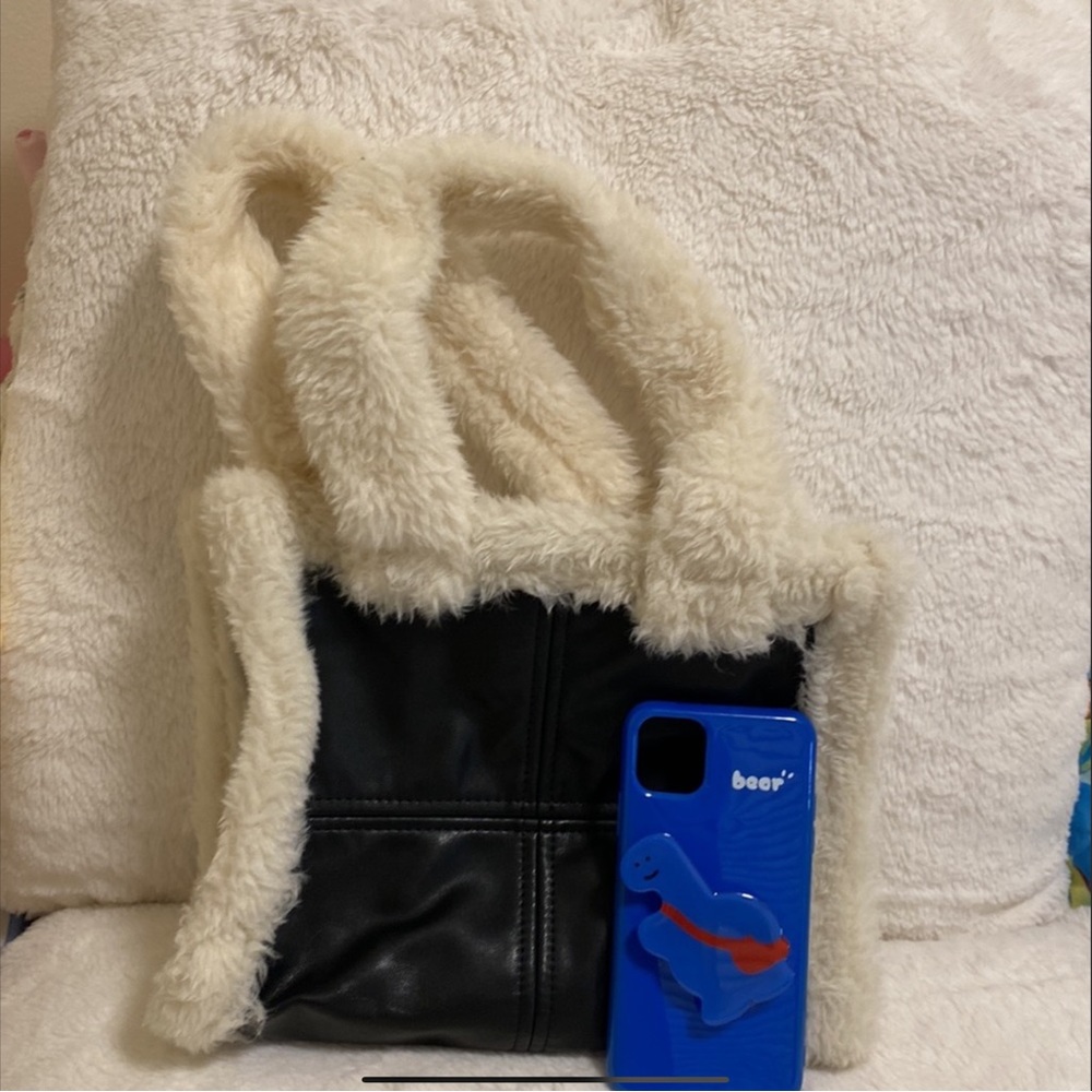 Durable efficient sized fake fur small tote bag.
